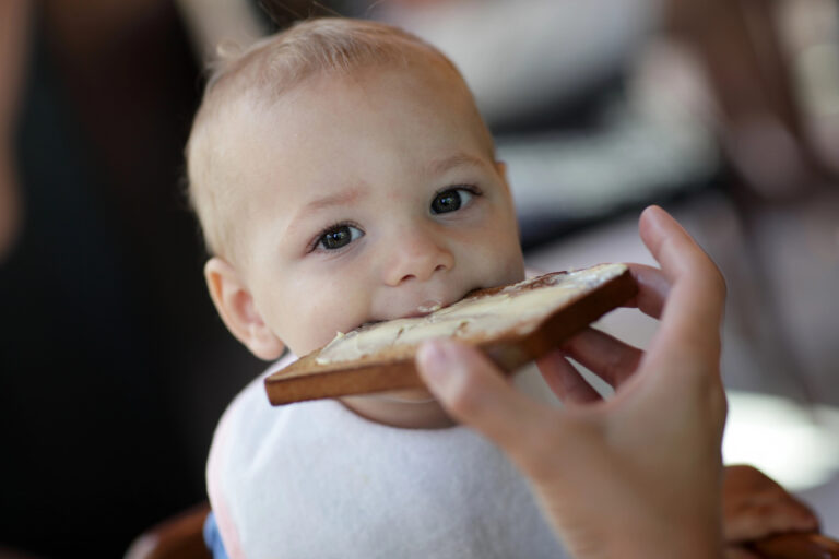 Toddler eating toast