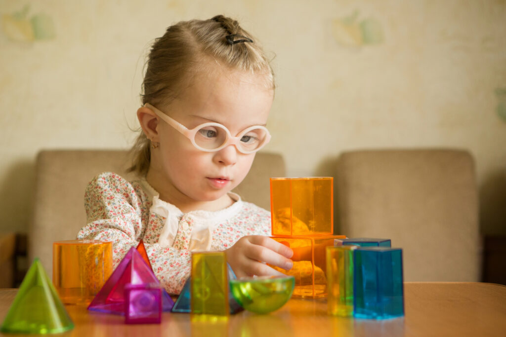 Child using containers to learn shapes and colors