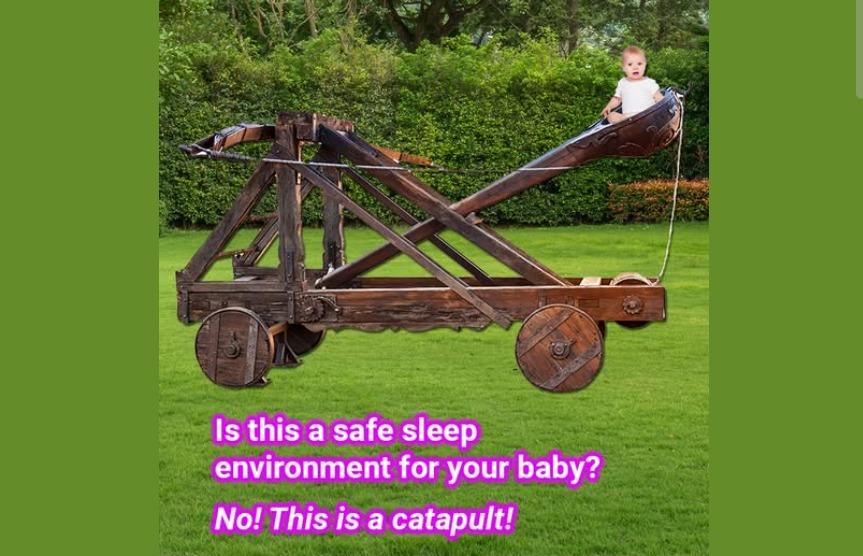 Image is a baby in a wooden catapult