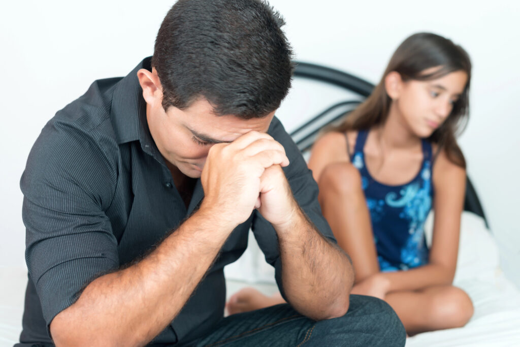 Worried father with her troubled teenage daughter