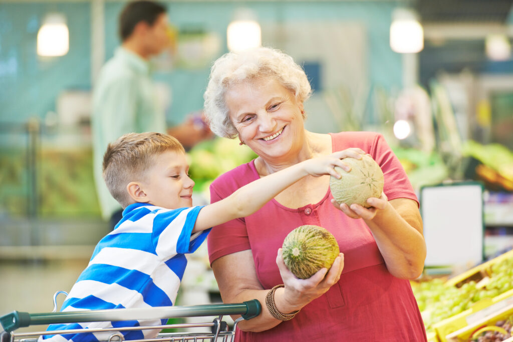 Grandma helps boy pick out groceries