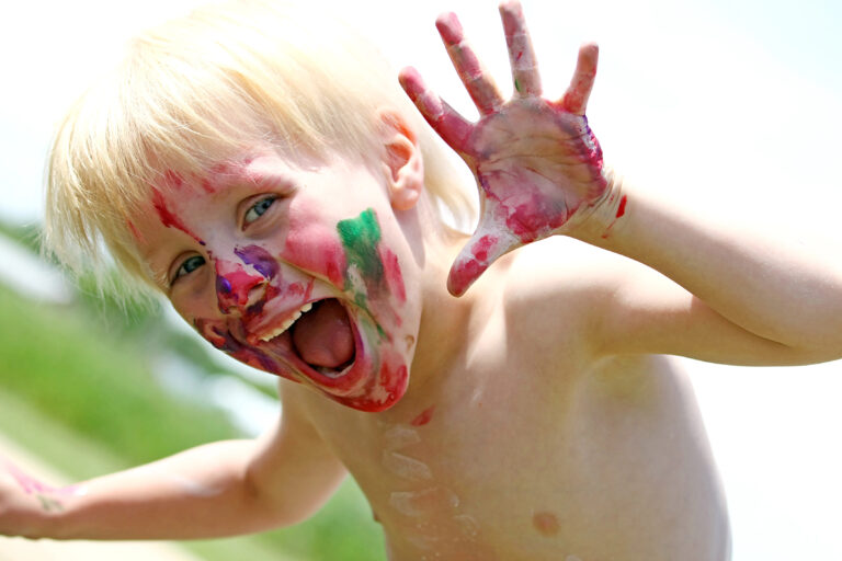 Happy Young Child with Messy Painted Face
