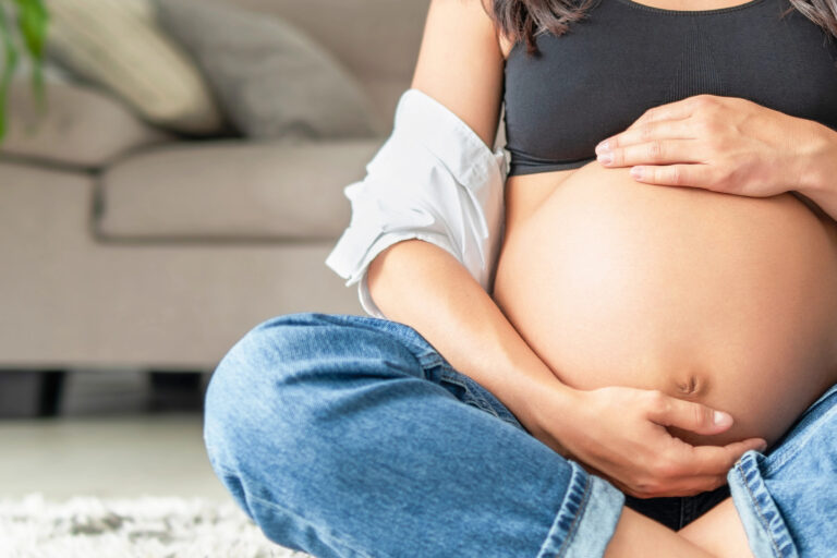 Pretty pregnant woman at home