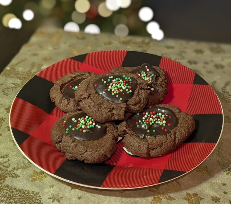 chocolate thumbprint cookies with holiday sprinkles on a plate