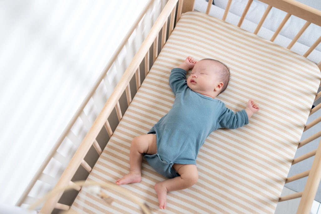 Baby sleeping in plain safe crib