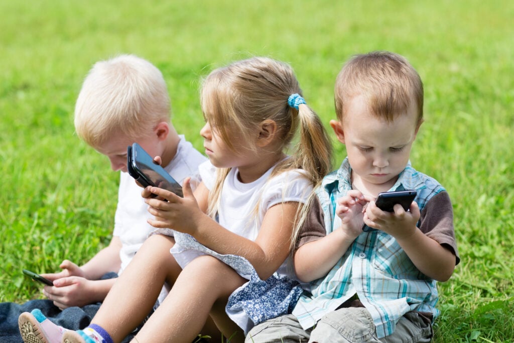 Cute children using smartphones